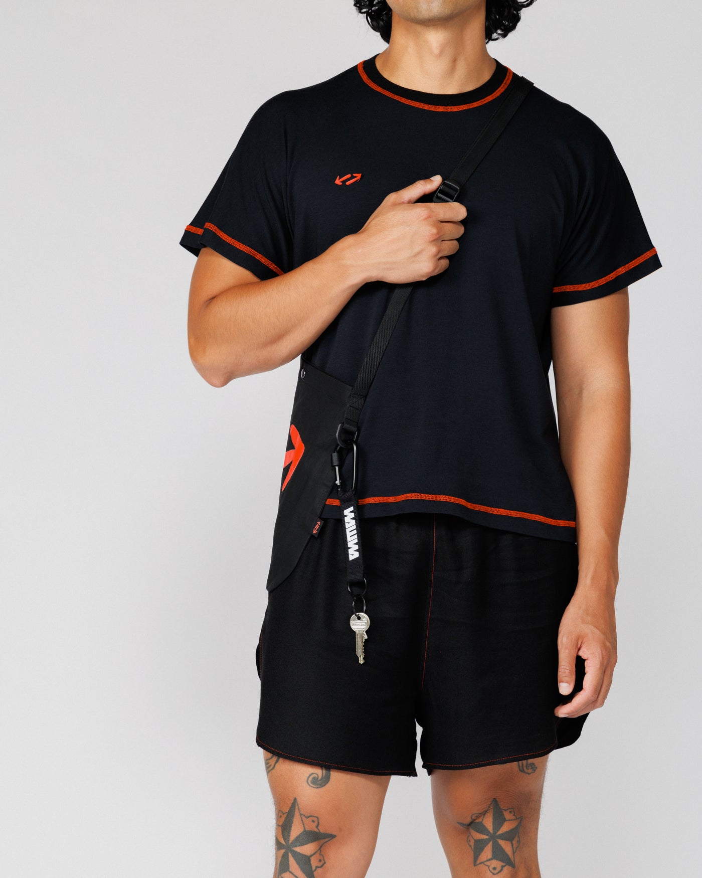 Outnback Bog Tee in black worn with WAWWA crossbody bag, styled in use