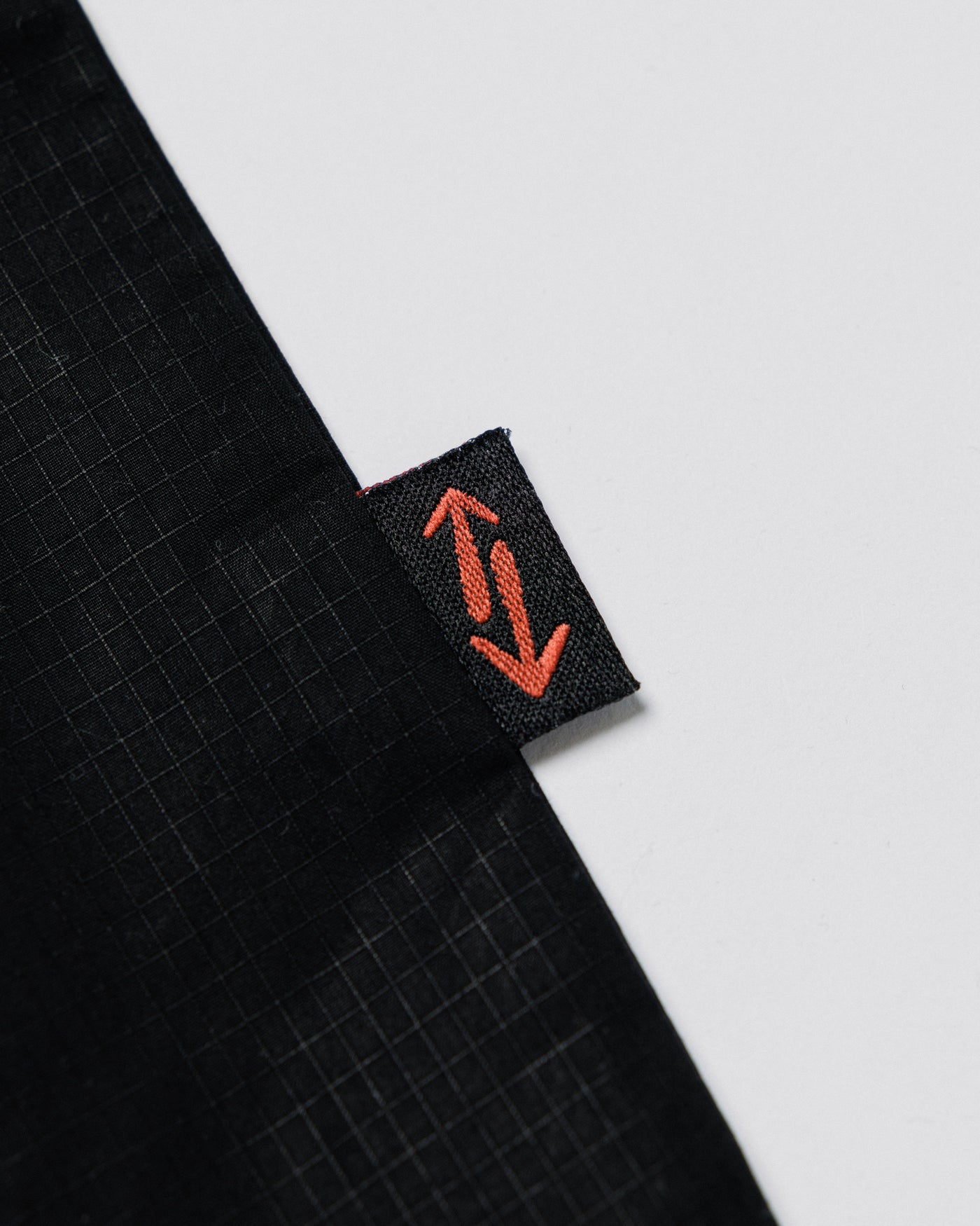 Outnback Musette in black, woven logo tag detail