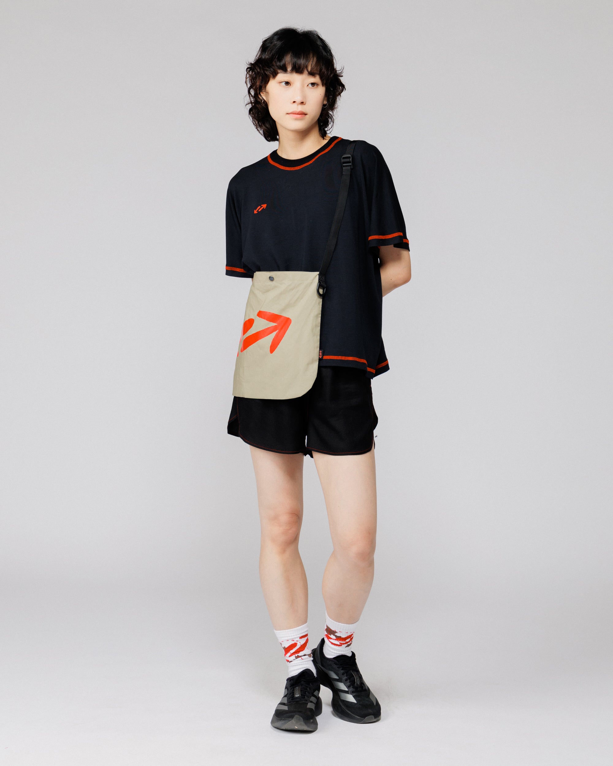 Outnback Musette in stone worn crossbody, full-body front view on model