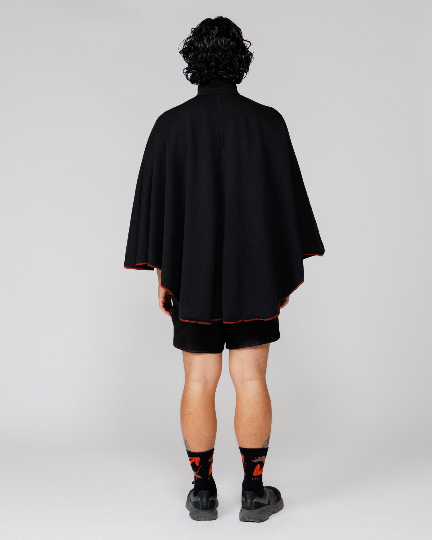 Model wearing the Outnback Recovery Cape in black, full-length back view
