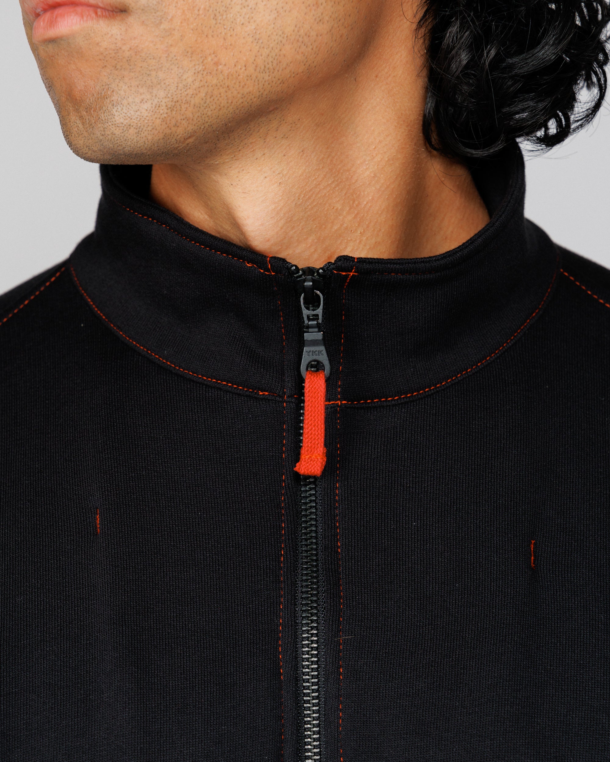 Close-up of the Outnback Recovery Cape funnel collar and zip worn by model