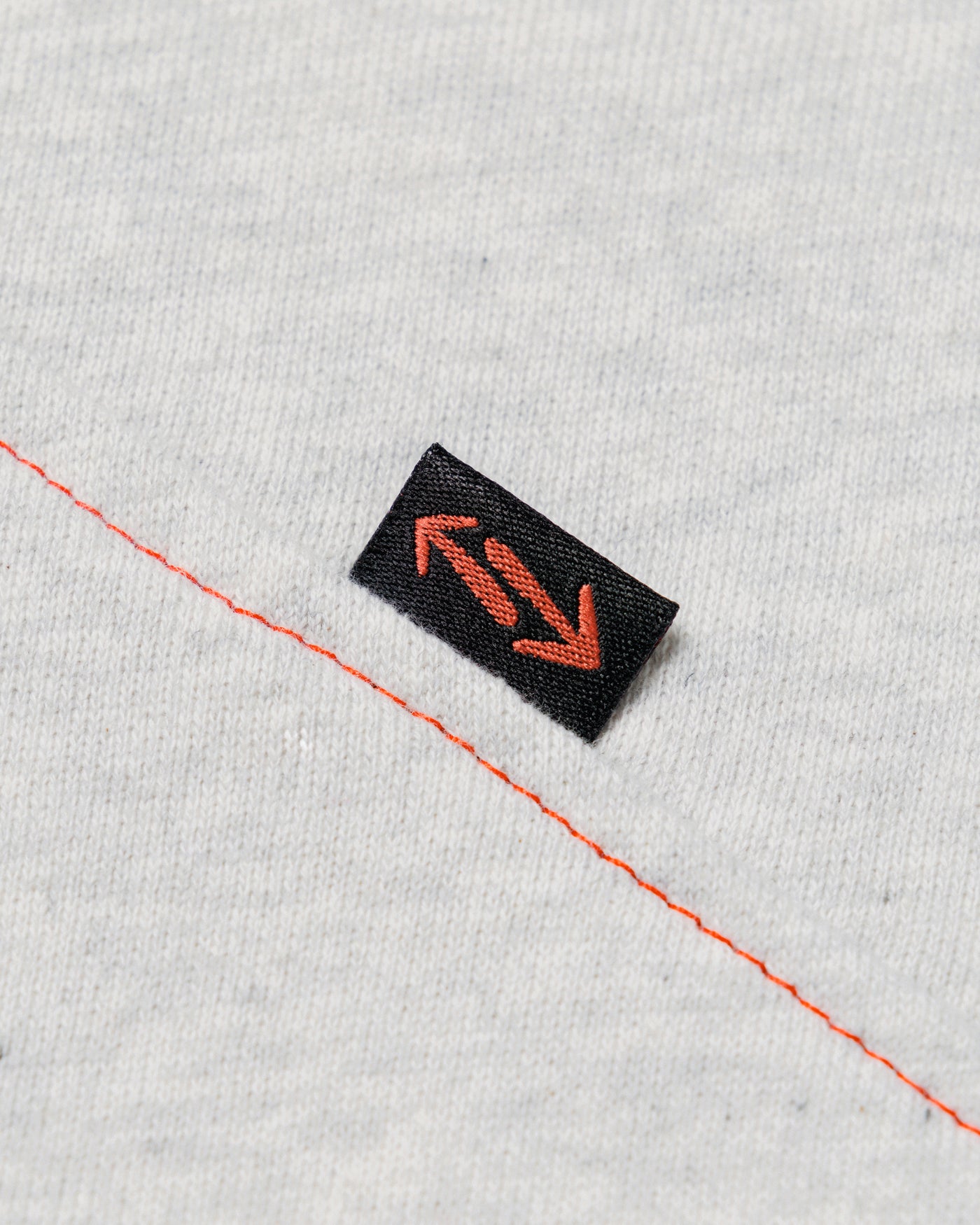 Outnback Recovery Cape in marl grey, woven arrow logo label detail
