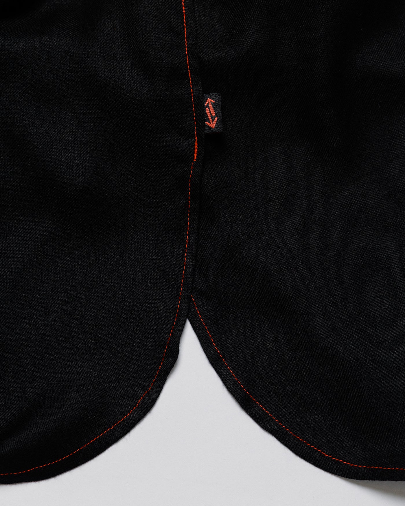 Outnback Running Short in black, curved hem and logo tab detail