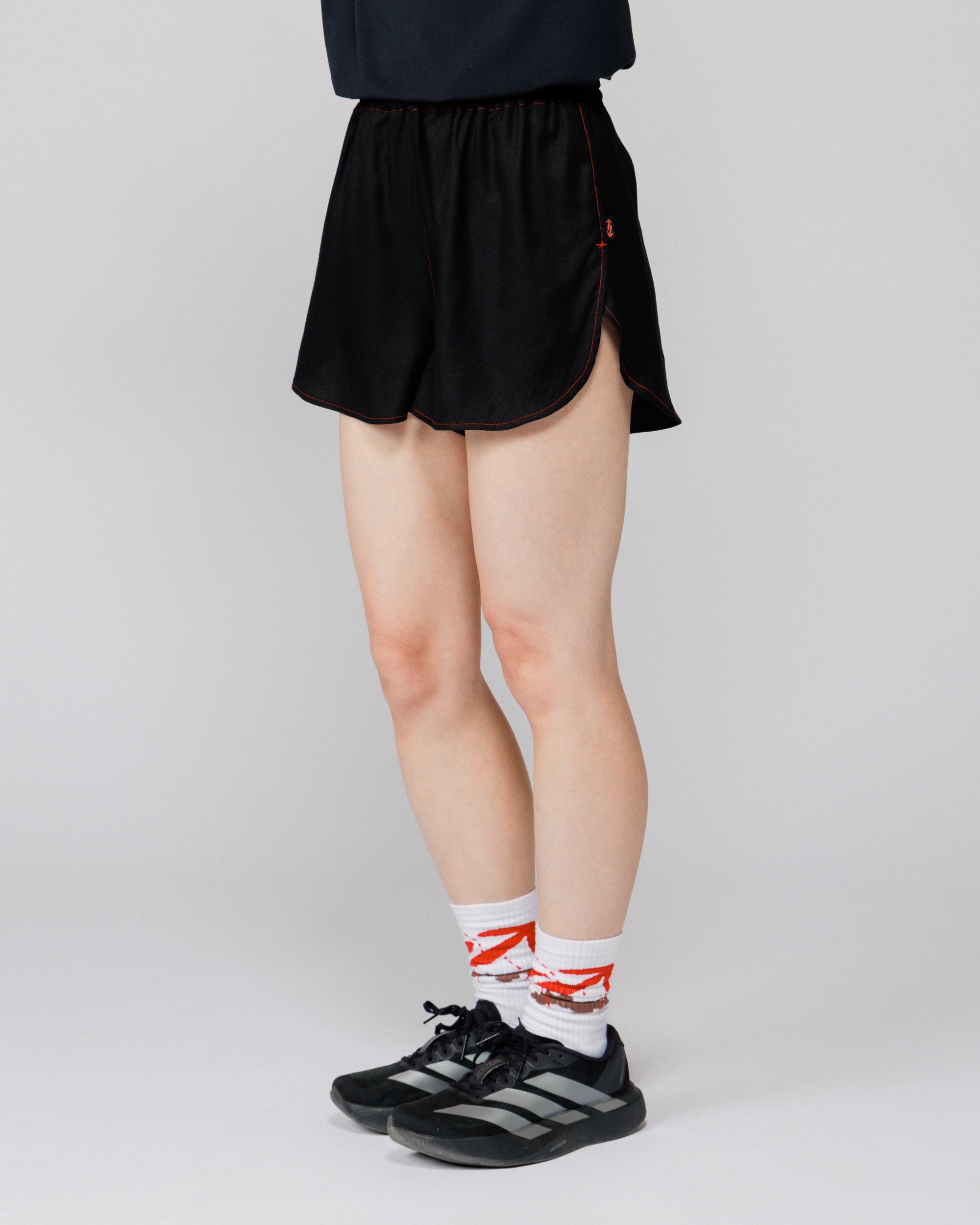 Outnback Running Short in black, cropped back view on model