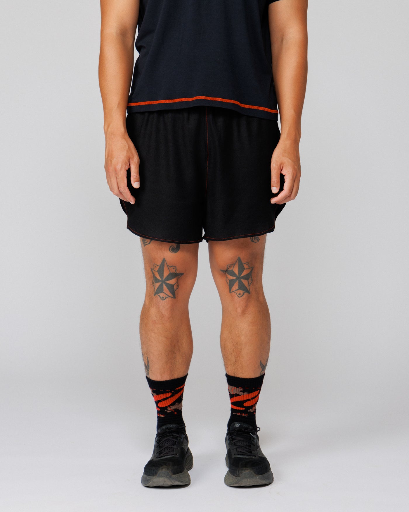 Outnback Running Short in black, cropped front view showing fit through the leg