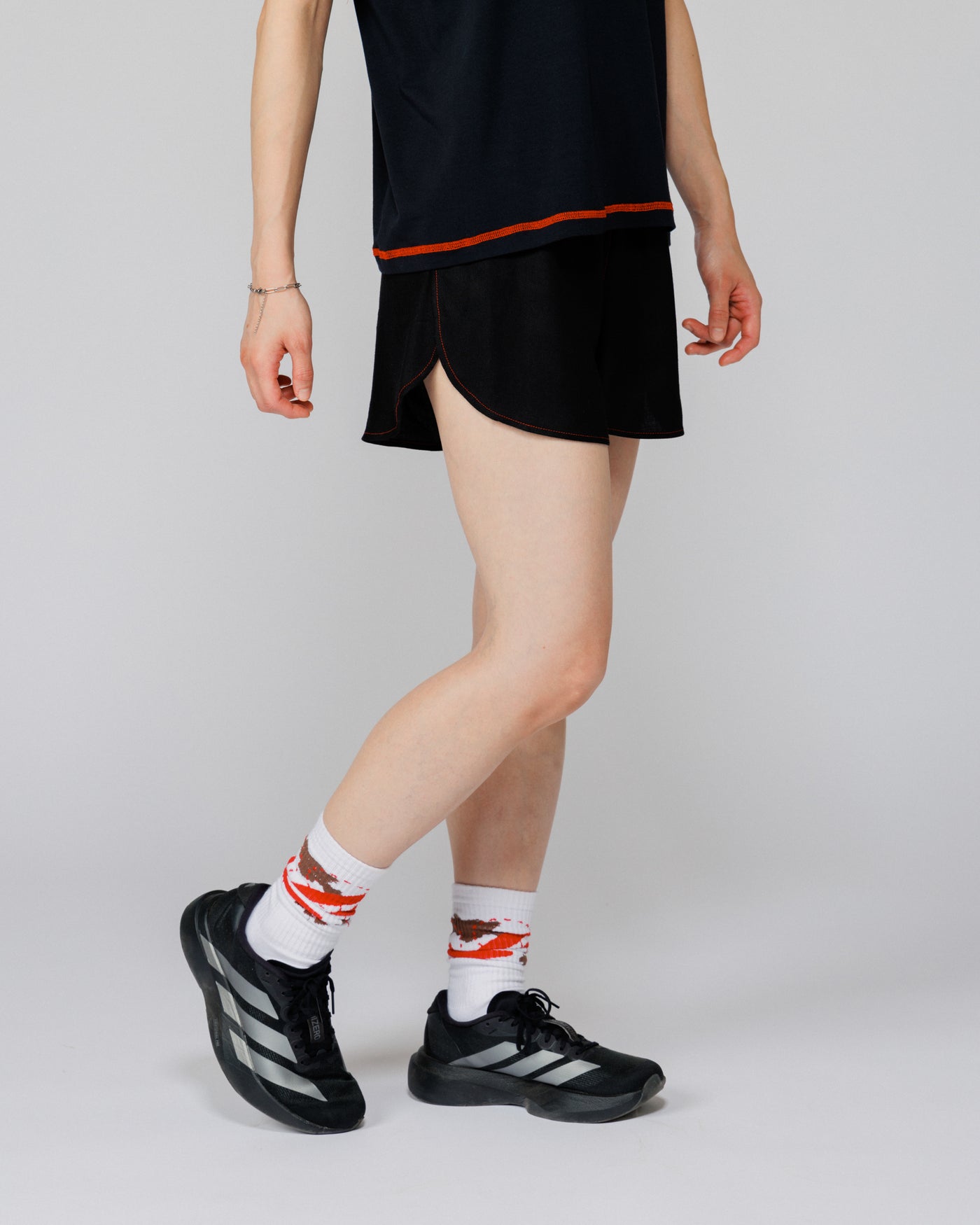 Outnback Running Short in black, cropped view on model mid-stride