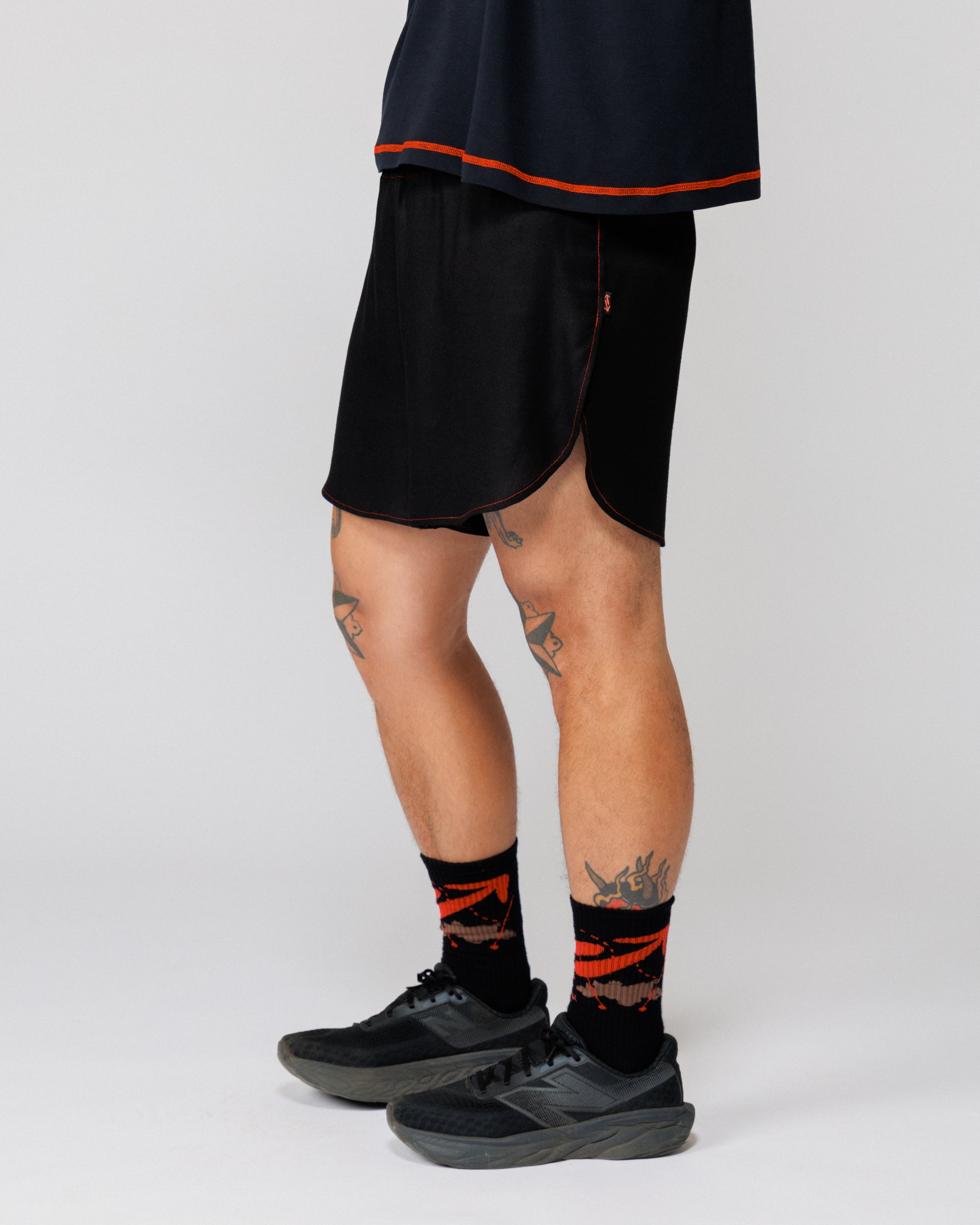 Outnback Running Short in black, cropped three-quarter side view on model