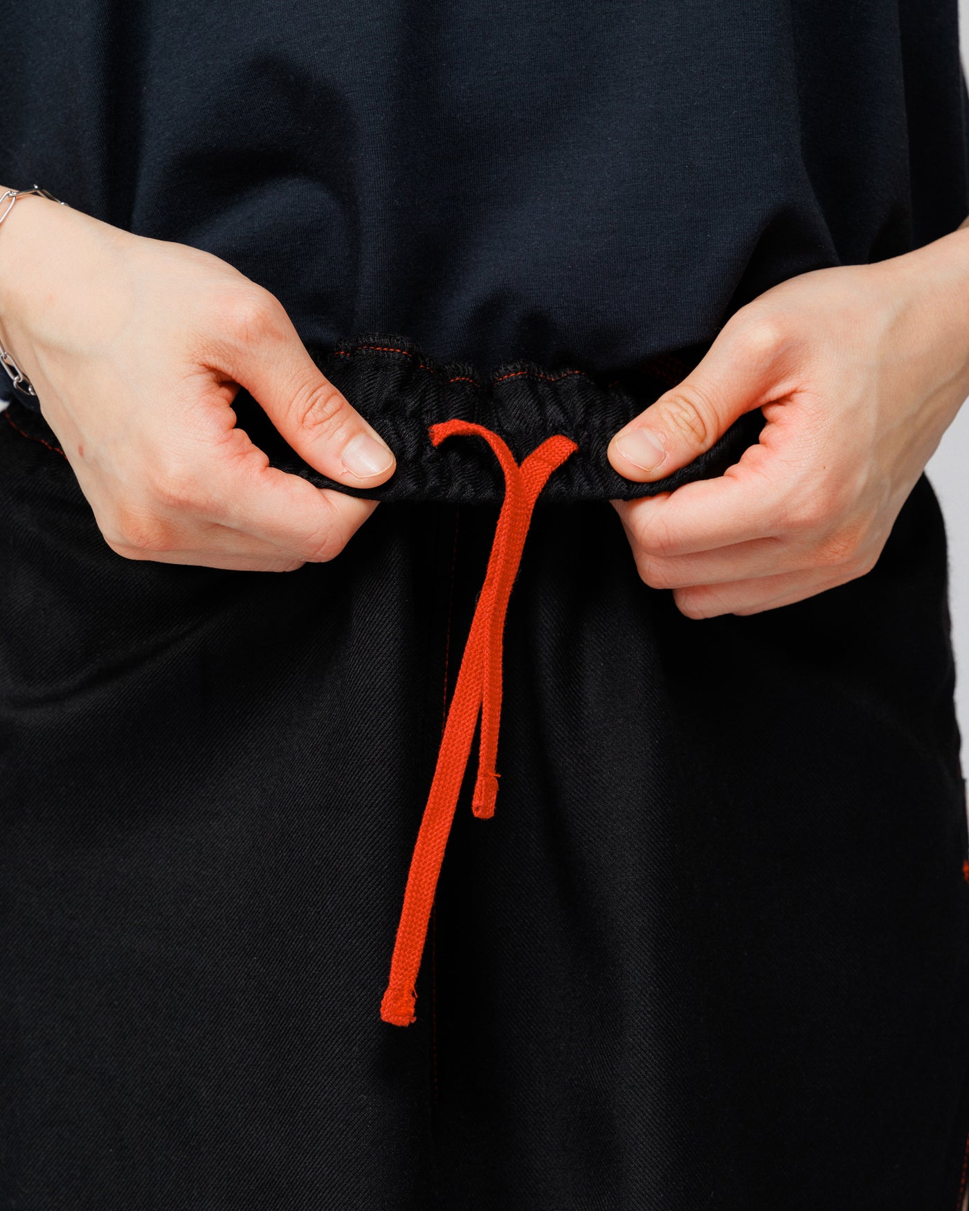Outnback Running Short in black, close-up of the red drawcord at the waistband