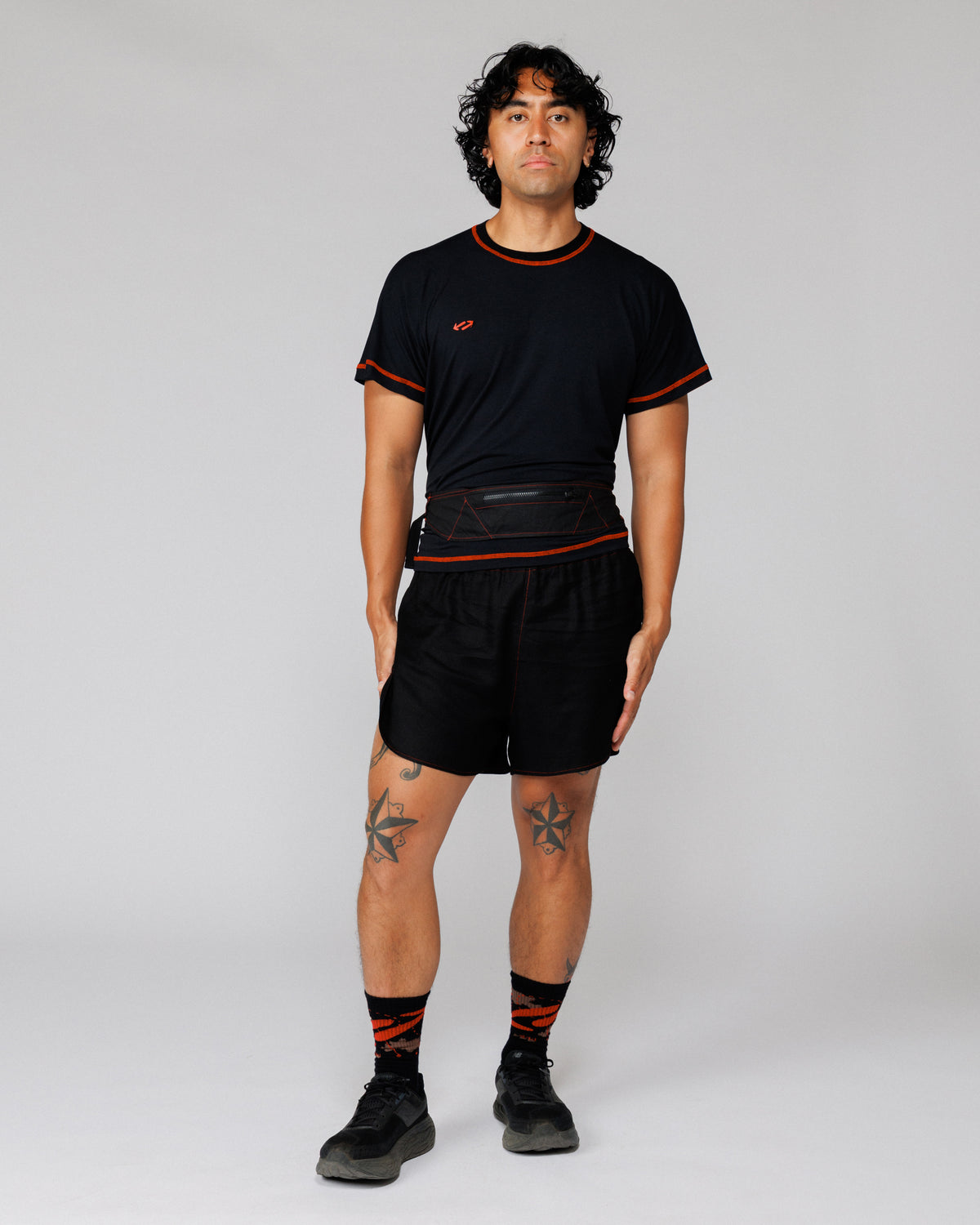 Model wearing the Outnback Running Strap in black at the waist, front view