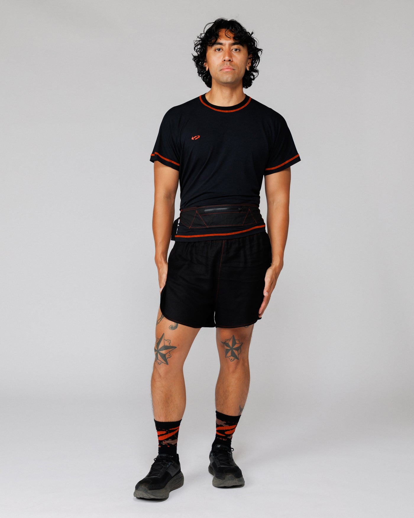 Model wearing the Outnback Running Strap in black at the waist, front view