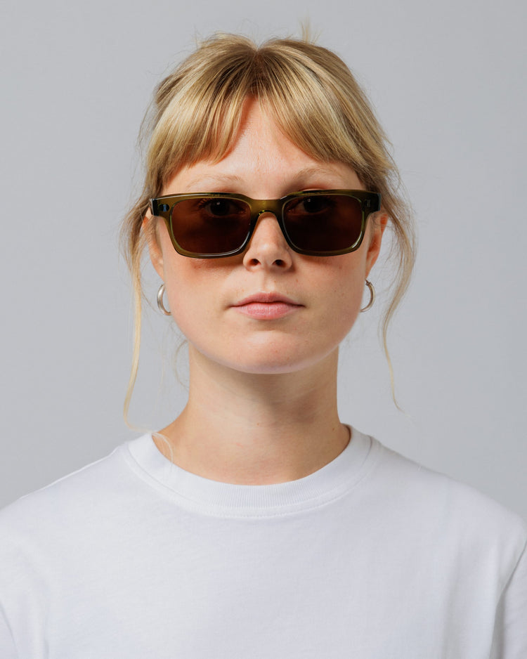 Female model wearing Solaris Sunglasses in khaki, front view